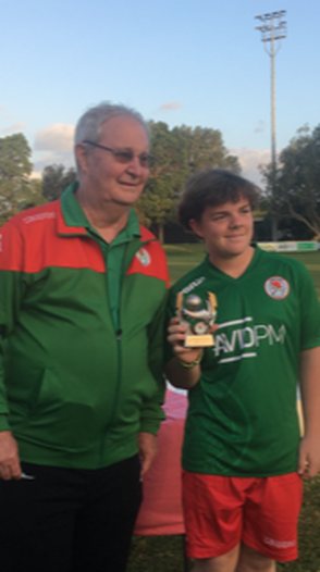 Peter Stone at Adamstown Rosebud presenting an award to a young player