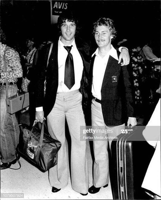 Peter Stone and a teammate with their luggage, travelling with the team